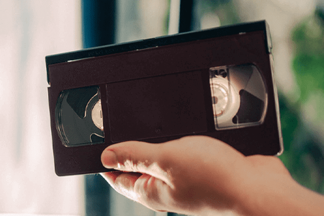 Customer bringing VHS, MiniDV, Hi8, or 8mm tapes for digital conversion in Cardiff